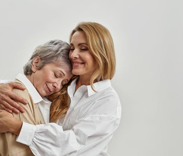 Senior en haar dochter omhelzen elkaar